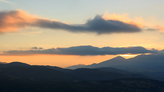 silhouette of mountain under gray sky thumbnail