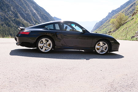 black coupe parked near mountains near daytime thumbnail