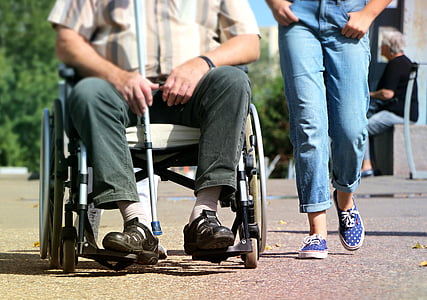 man siting on wheelchair beside person in jeans thumbnail