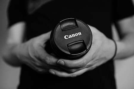 person holding black Canon DSLR camera thumbnail