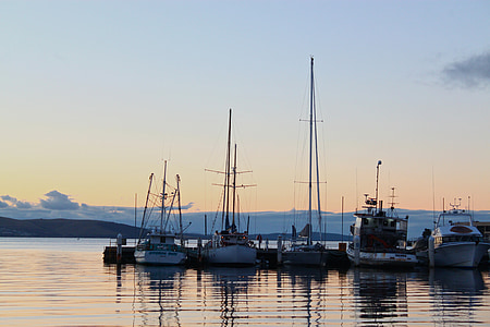 five boats on calm body of water near dock thumbnail