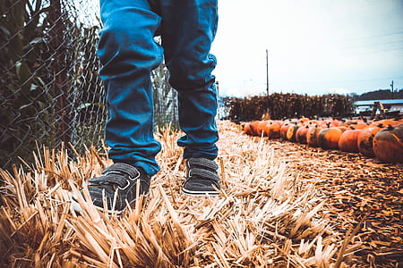 man standing on brown grass field thumbnail