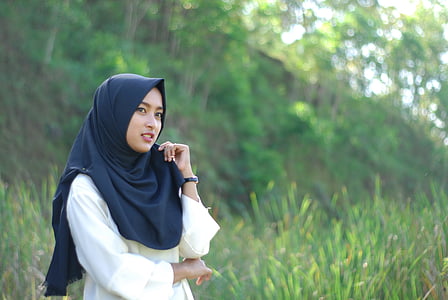 woman wears black hijab surrounded by green grass during daytime thumbnail