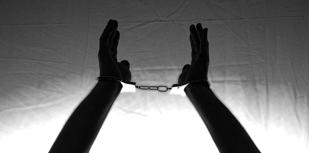 person's hand with handcuffs thumbnail