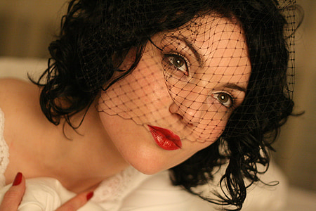 woman in black fascinator hat thumbnail