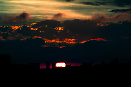 silhouette photography of high rise buildings during golden hour thumbnail