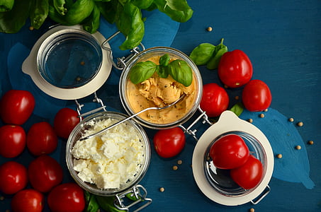 red tomatoes beside yellow and white dips thumbnail