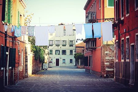 hang assorted-color clothes between buildings thumbnail