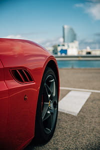 Side view of a red sports car with alloy wheels thumbnail
