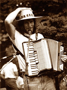 photography of man playing accordion thumbnail