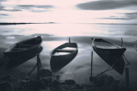 three boats on clear body of water grayscale photo thumbnail
