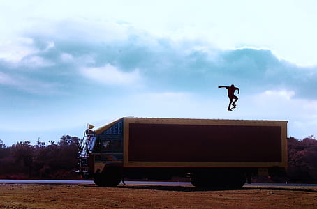 Brown Truck With Man With Skateboard on Top thumbnail