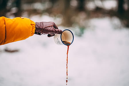 person holding enamel mug thumbnail