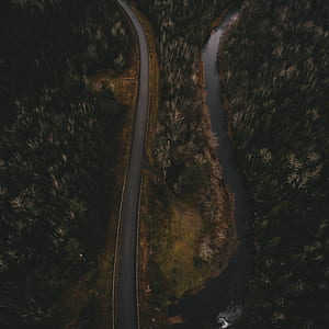aerial photo of concrete road near river thumbnail