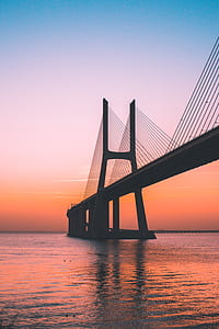 black concrete suspension bridge photo thumbnail