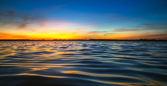 photo of body of water during golden hour thumbnail