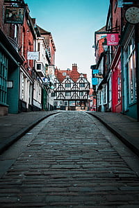 empty street between mid-rise buildings during daytime photo thumbnail