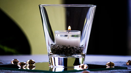 clear shot glass with white candle inside thumbnail
