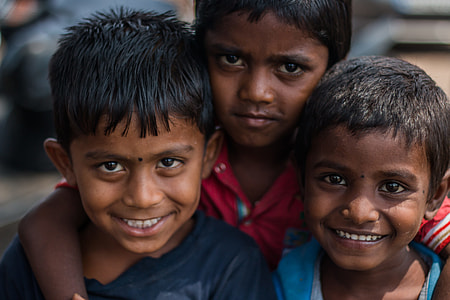 selective focus photography of three boys thumbnail