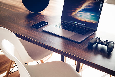 MacBook Pro on brown wooden desk thumbnail