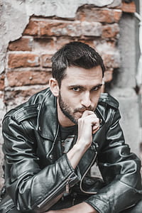 man in black leather jacket posing for photo thumbnail