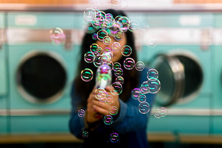 selective focus photography of girl blowing bubbles thumbnail