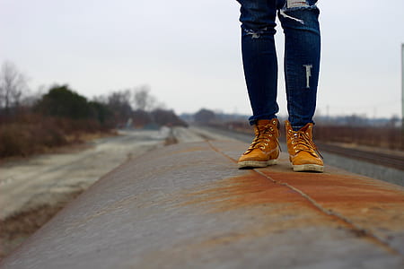 person standing on gray metal platform during daytime thumbnail