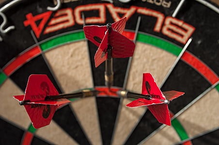 three pink dart pins in dartboard thumbnail