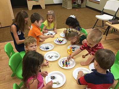 group of kid playing beside brown wooden table thumbnail