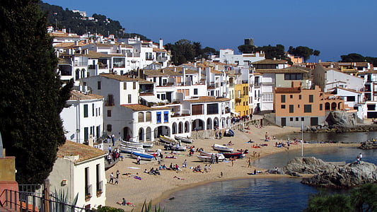 group of people near body of water and houses thumbnail