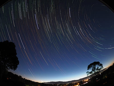 time-lapse photography of stars with silhouette of trees thumbnail