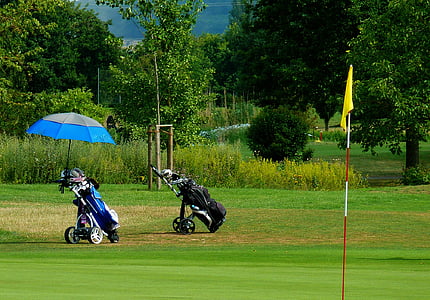 blue and black golf bag on green grass field thumbnail