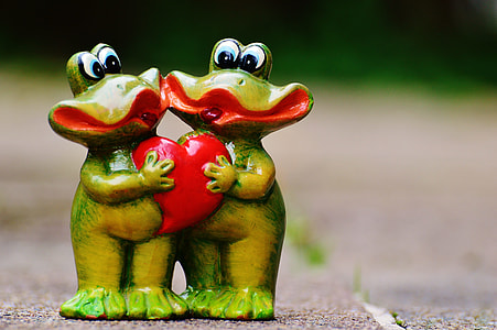 two ceramic frogs holding heart figure thumbnail