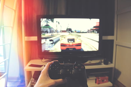 person playing black Sony DualShock3 thumbnail