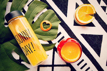 Sunny Day bottle near sliced orange with heart peel thumbnail