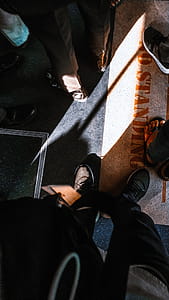 Person Standing on Brown and Black Printed Surface thumbnail