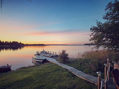 white cuddy boat docked near grass field thumbnail