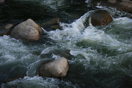 flowing river with boulders thumbnail