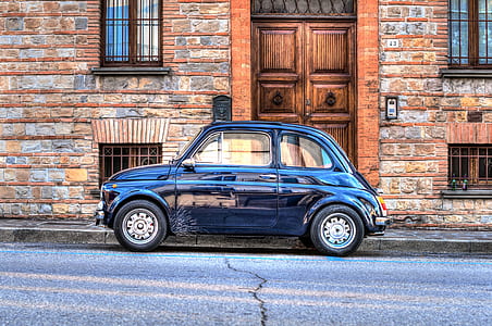 blue MINI Cooper 3-door hatchback parked on roadside near brown bricked building thumbnail