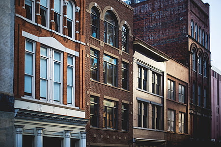 brown building beside buildings thumbnail