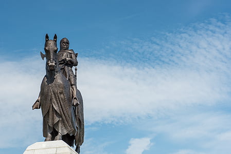 man riding horse statue under white clouds during daytime thumbnail