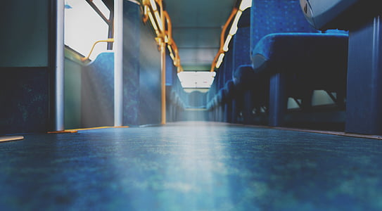 low angle photography of blue vehicle seats inside bus thumbnail