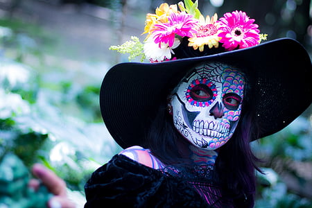 woman in black dress wearing black hat with sugar skull face paint thumbnail