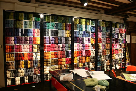 assorted-color clothes lot on black shelf thumbnail