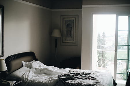 white table lamp beside bed thumbnail