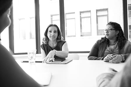 Photo of Four People Having Conversation in Room thumbnail