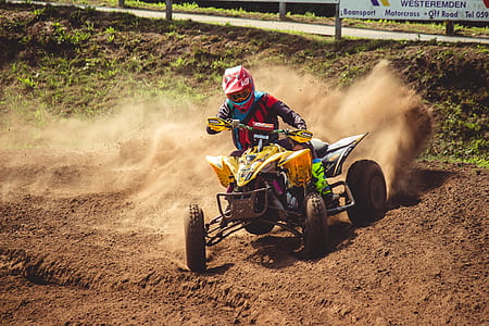 man riding ATV drifting on sand thumbnail
