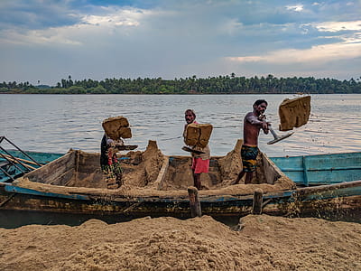 Three Person Standing On Blue Boat thumbnail