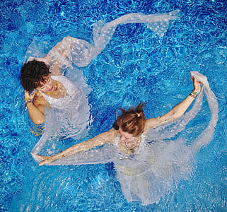 two women swimming on pool thumbnail