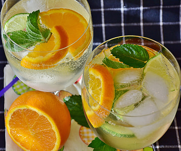 two clear drinking glasses with fruit juices thumbnail